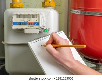 Person Writes Indication Gas Meter In Notebook.