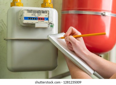 Person Writes Indication Gas Meter In Notebook.