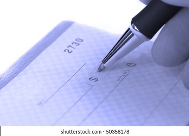 Person Writing Check With Pen And Checkbook