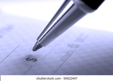 Person Writing Check With Pen And Checkbook