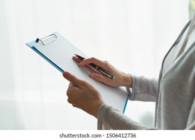 person writing on clipboard with pen, secretary or inspector idea, formal clothes - Shutterstock ID 1506412736