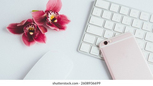 Personal Brand image of a Flat-Lay creative image including one pink pink orchid flower, a partial section of a white keyboard, computer mouse, and a rose gold smartphone. Facebook Ad crop.