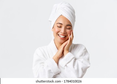 Personal Care, Women Beauty, Bath And Shower Concept. Close-up Of Beautiful Happy Asian Woman In Towel And Bathrobe Touching Face Gently, Smiling White Teeth, Promo Of Skin Care And Hygiene Products