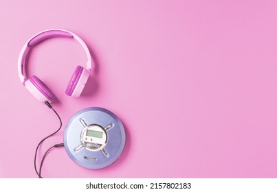 Personal compact portable CD player disks purple headphones on a pink background. - Powered by Shutterstock