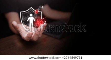 Personal data breach and cybersecurity concept. Broken shield protecting human figure is attacked, held by a man using laptop. Identity theft protection, web scam, information leak, exposed, hacked