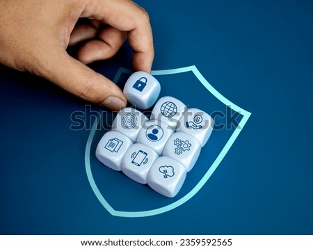 Personal data protection and cyber security network system of internet technology concepts. Secure lock icon block in hand placed in digital safety shield area with privacy information symbol group.