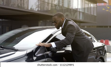 Personal Driver Of Important Person Wiping Dust From Chic And Shiny Auto