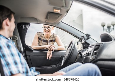 Personal Driver. A Pretty Business Woman Getting Into A Taxi Cab . Skinner Wait Businesswoman Inside Luxury Car Young Adult Girl Walk Outdoor To Auto. Empty Space For Inscription. Couple Flirting.