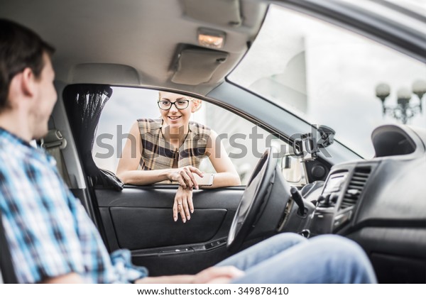 personal driver. A pretty business woman\
getting into a taxi cab . Skinner wait businesswoman inside luxury\
car Young adult girl walk outdoor to auto. Empty space for\
inscription. couple\
flirting.