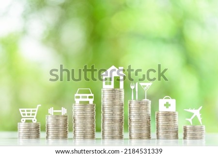 Personal expense and weekly budget, financial concept : Seven coin stacks with logo on top e.g a shopping cart, a dumbbell, a car, a house, a fork a knife and a glass of cocktail, first aid kit, plane Foto stock © 