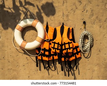 Personal Flotation Device And Life Belt On Wall