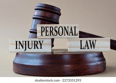 PERSONAL INJURY LAW - words on wooden blocks against the background of a judge's gavel with a stand. - Shutterstock ID 2273351295