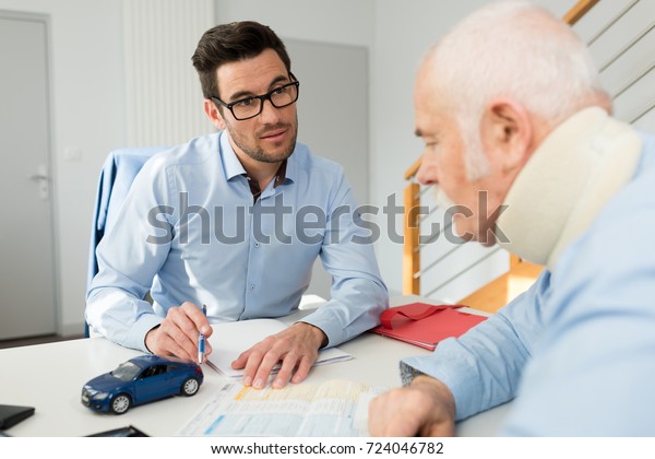 personal injury lawyer in meeting with client\
wearing neck brace
