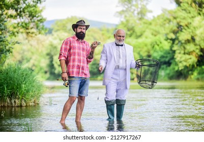 Personal instructor. Bearded man elegant businessman fish together. Learn to fish. Fishing skills. Fish with companion who help in emergency. Expert fisherman. Men friends relaxing river background