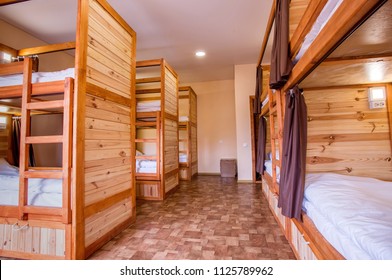 Personal Lighting Over Each Bed. Bunk Wooden Beds In The Hostel. Five Bunk Beds In One Hostel Room