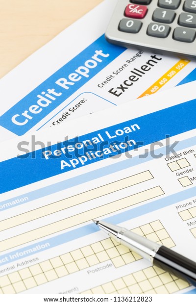Personal loan application form excellent credit score\
with calculator, and\
pen