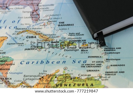 personal notes of someone planning a trip to the caribbean sea over a closeup map of Cuba, Haiti, Jamaica, Dominican, puertorico and the Bahamas