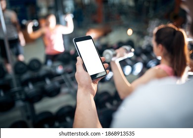 Personal Online Workout With Mobile Phone Or Smartphone App At Gym