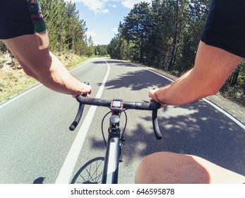 Personal Perspective Cycling. Young Adult Man Climbing On A Mountain Road With A Racing Bicycle On A Sunny Spring Day. POV