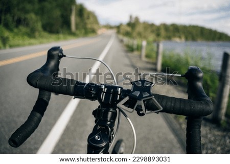 Personal perspective of a cyclist riding a road bicycle on the road. High quality photo