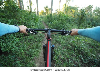 Personal perspective shot of a man mountain biking in tropical environment Dominican Republic.