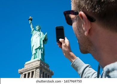 Personal Point Of View Perspective Of Tourist Taking Photo Of The Statue Of Liberty With His Mobile Phone