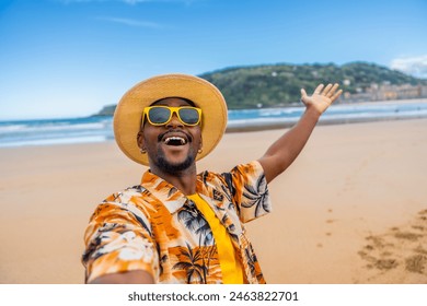 Personal point of view of a young african man in colorful clothes, sunglasses and hat taking a selfie enjoying holidays on the beach - Powered by Shutterstock