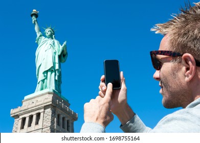 Personal Pov Perspective Of Tourist Taking Picture Of The Statue Of Liberty With His Mobile Phone