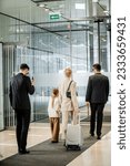 personal protection, bodyguards in formal wear and sunglasses escorting blonde woman and her daughter, leaving hotel, private safety, rich lifestyle, security service