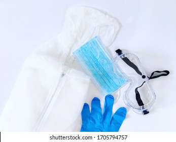 Personal Protective Equipment PPE For Coronavirus Frontline Workers Including Protection Suit, Face Mask, Gloves And Goggles Against White Background