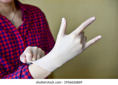 Personal Protective Equipment Vinyl Disposable Gloves, Woman Puts Her Hands In Gloves.