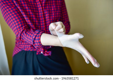 Personal Protective Equipment Vinyl Disposable Gloves, Woman Puts Her Hands In Gloves.