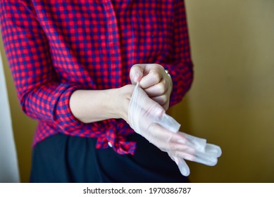 Personal Protective Equipment Vinyl Disposable Gloves, Woman Puts Her Hands In Gloves.