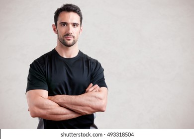 Personal Trainer With Is Arms Crossed, Isolated In Grey