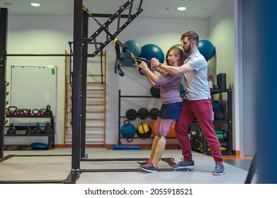 Personal trainer assisting woman with disabilities in her workout 
 - Powered by Shutterstock
