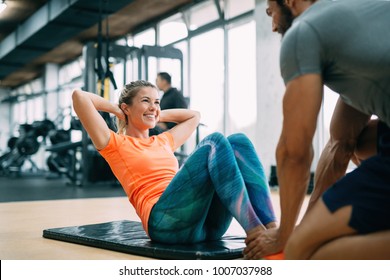 Personal trainer assisting woman lose weight - Powered by Shutterstock