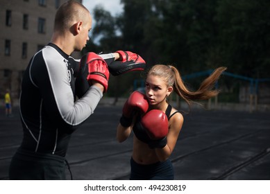 personal trainer coach men and women engaged in boxing at the stadium - Powered by Shutterstock