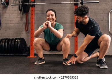 Personal trainer with a first-time trainee correcting habits in the exercise room. Personalized individual training - Powered by Shutterstock - Get 15% off with code: PIKWIZARD15