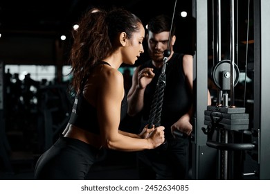 A personal trainer guides a brunette sportswoman in a workout at the gym, both driven and focused on achieving fitness goals. - Powered by Shutterstock