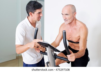 Personal trainer helping with spinning exercise - Powered by Shutterstock