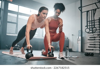 Personal trainer, kettle bell and stopwatch with a black woman coaching a client in a gym for her workout. Health, exercise or training and a female athlete doing a plank with her coach taking time - Powered by Shutterstock