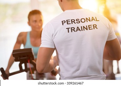 Personal trainer on weights lifting training with  client - Shutterstock ID 339261467