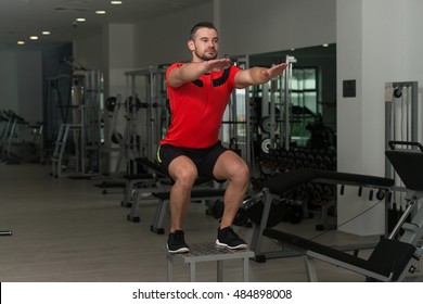 Personal Trainer Performing A Box Jump During A Fitness Workout