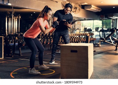 Personal Trainer To Practice Exercise With A Jump On The Box