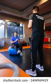 Personal Trainer Practicing A Balance And Coordination Exercises With A Client. New Gym Member Training With A Healthy Instructor