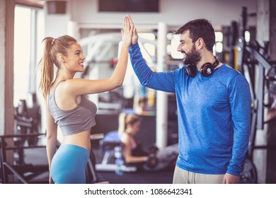 Personal trainer and a sports woman who are enthusiastic about exercises. - Powered by Shutterstock