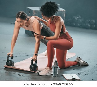 Personal trainer, stopwatch and fitness with a woman athlete lifting weights during a plank in the gym for a workout. Coach, time and exercise with a female training using kettle bell equipment - Powered by Shutterstock