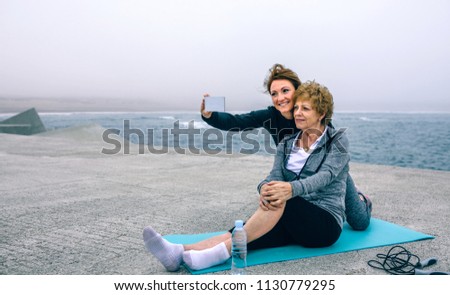 Similar – Two women walking by sea pier