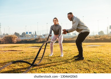 Personal Trainer Training A Girl With Ropes On The Outside