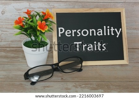 personality traits concept. blackboard with potted flower